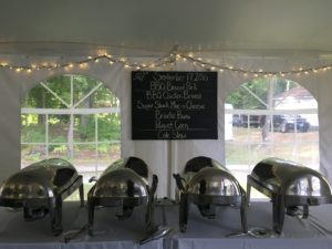 buffet line and menu under wedding tent